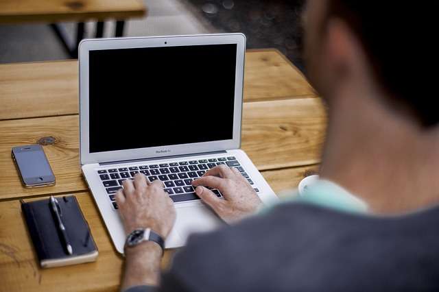 man sitting on desk working